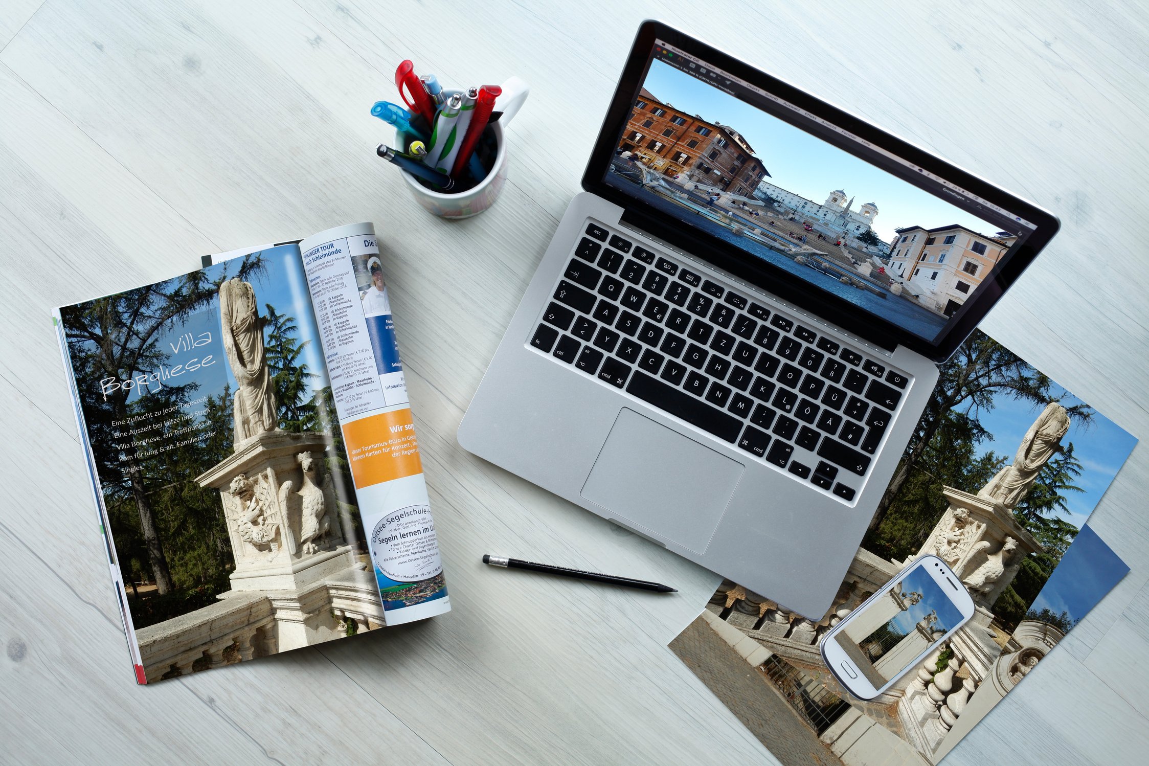 Top View of Laptop and Magazines on a Desktop